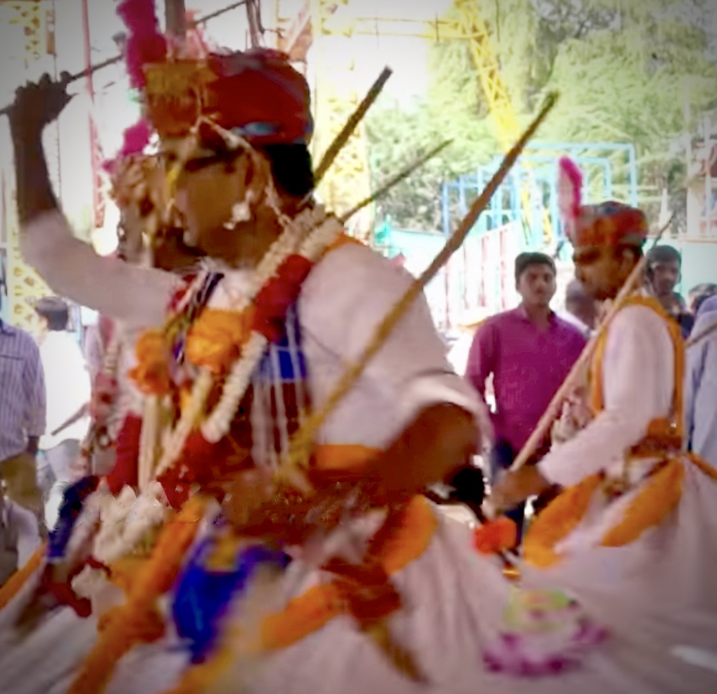 People dancing with sticks