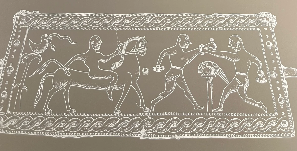The plate drawn out — two boxers, a grip in each fist. Bronze belt-plate, Brezje, Slovenia, c. 500–400 BC