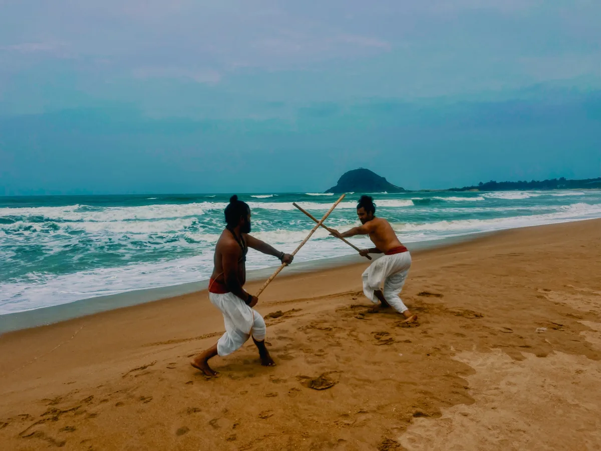 Jodi practice with the Silambam kambu on the shore